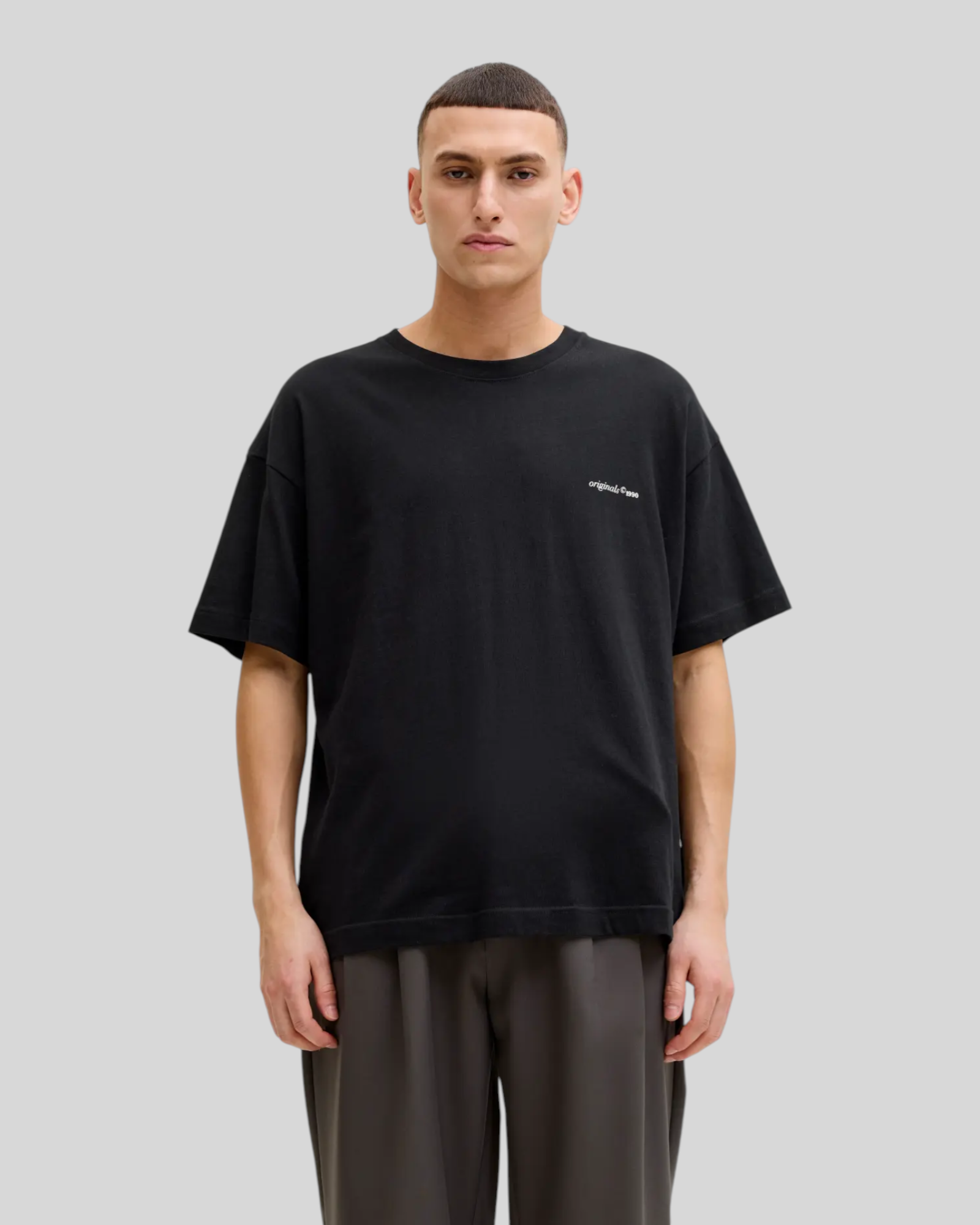 Brillantina Store black 100% cotton oversized t-shirt with crew neck and short sleeves, featuring a small white graphic print on the front.