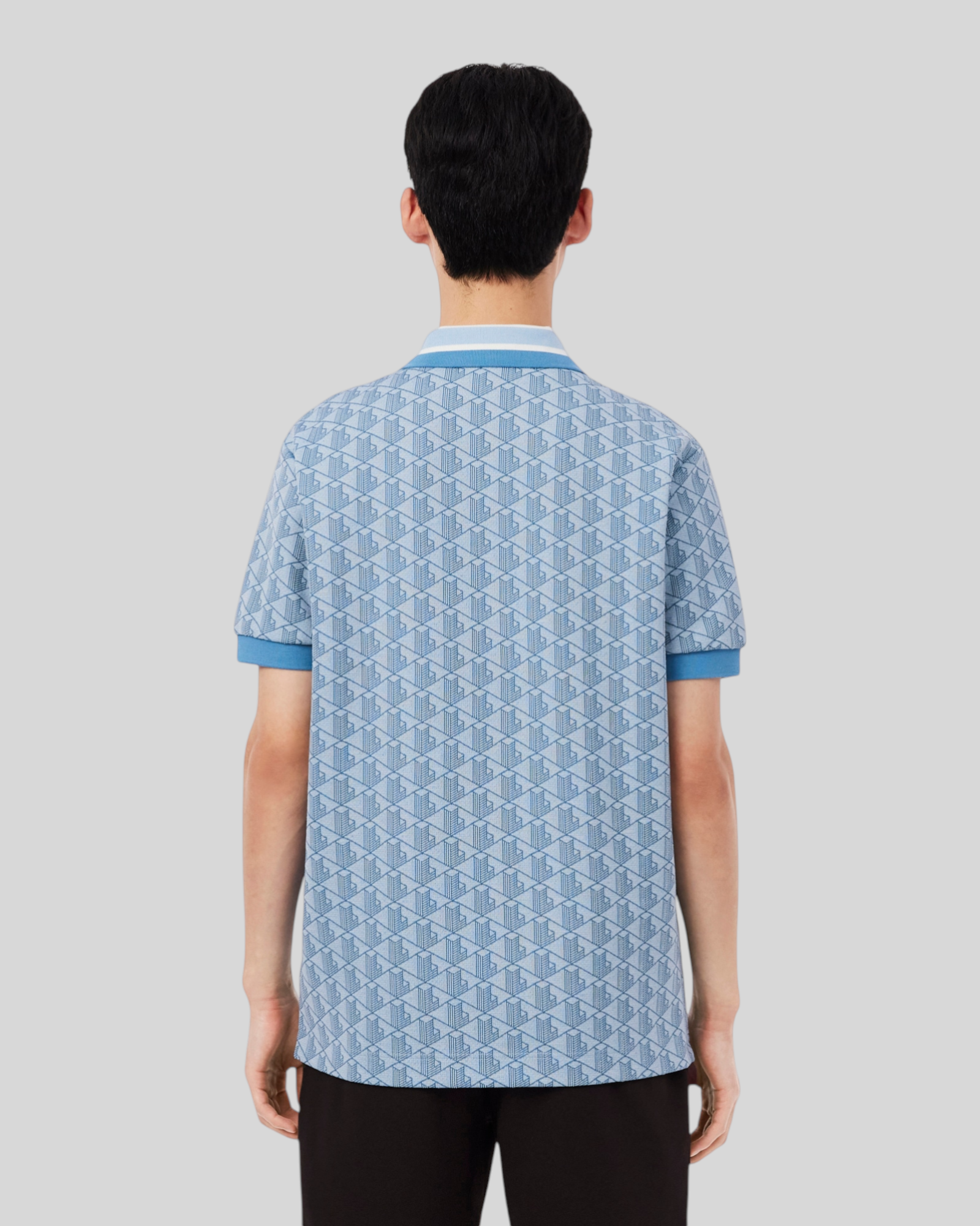 Brillantina Store light blue jacquard polo shirt with monogram pattern, contrast striped collar, and ribbed trim. Made from recycled polyester and organic cotton.